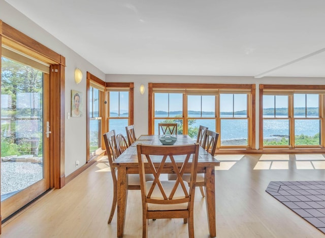 65 Grange Hall Rd, Sullivan, ME 04664 - dining room featuring a water view, baseboards, and light wood-style floors