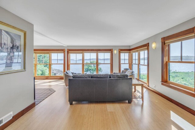 65 Grange Hall Rd, Sullivan, ME 04664 - living area featuring a water view, visible vents, baseboards, and light wood finished floors
