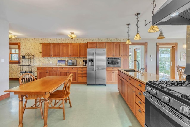 65 Grange Hall Rd, Sullivan, ME 04664 - kitchen featuring wallpapered walls, a sink, stainless steel appliances, brown cabinets, and extractor fan