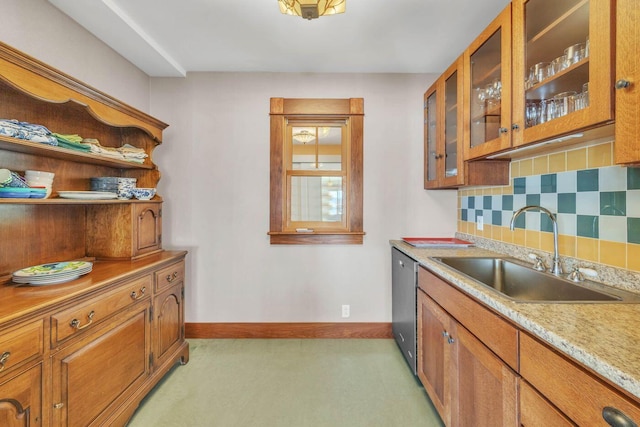 65 Grange Hall Rd, Sullivan, ME 04664 - kitchen with baseboards, a sink, brown cabinets, decorative backsplash, and light colored carpet