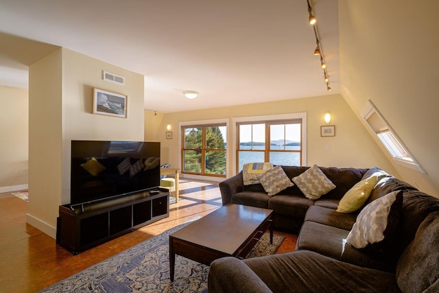 65 Grange Hall Rd, Sullivan, ME 04664 - living room with rail lighting, visible vents, and baseboards