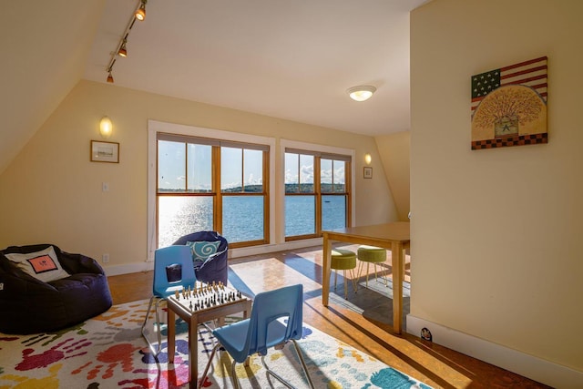 65 Grange Hall Rd, Sullivan, ME 04664 - interior space with baseboards, rail lighting, vaulted ceiling, and a water view