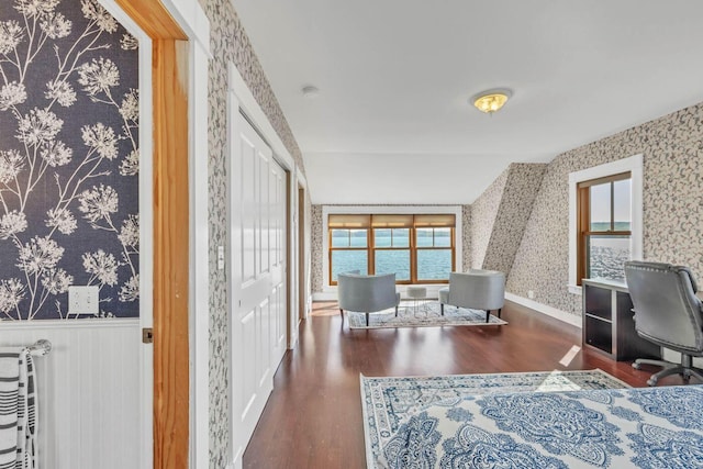 home office with a water view and dark wood-type flooring