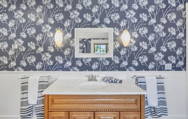 65 Grange Hall Rd, Sullivan, ME 04664 - bathroom with vanity, wallpapered walls, and a wainscoted wall