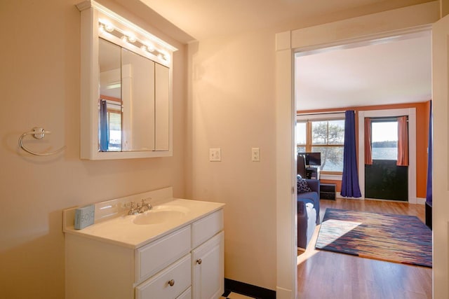 65 Grange Hall Rd, Sullivan, ME 04664 - bathroom with vanity, baseboards, and wood finished floors