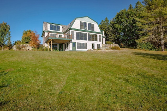 65 Grange Hall Rd, Sullivan, ME 04664 - back of house with a gambrel roof, a wooden deck, and a yard