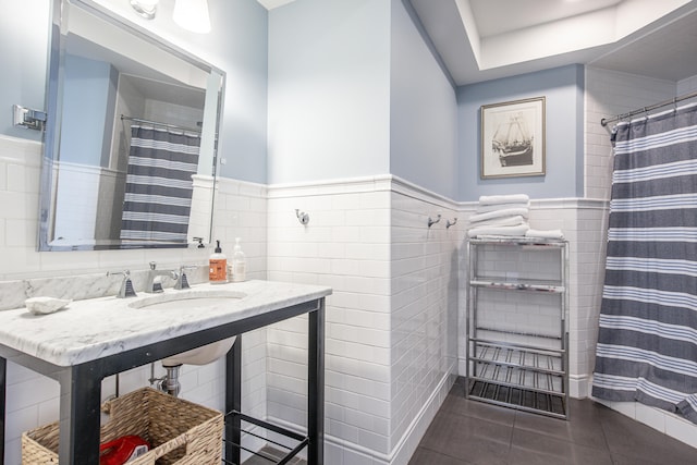 bathroom featuring sink, tile walls, tile patterned flooring, and curtained shower