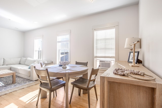 dining area featuring cooling unit and hardwood / wood-style floors