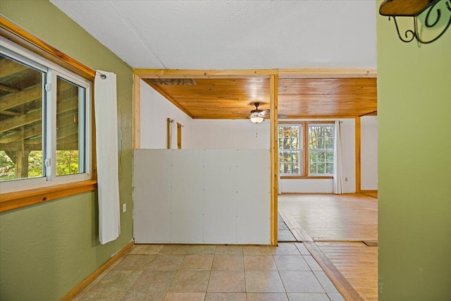 empty room with light tile patterned flooring and ceiling fan