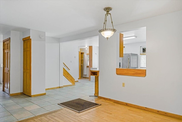 unfurnished room with light wood-type flooring