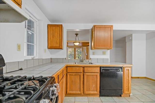 kitchen with kitchen peninsula, black appliances, sink, and tile countertops