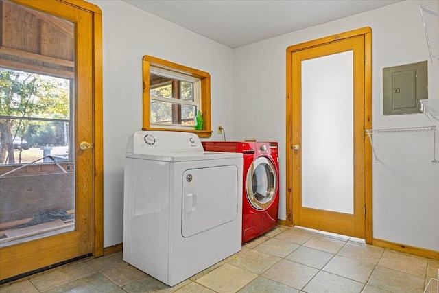 laundry room featuring electric panel, separate washer and dryer, and light tile patterned floors