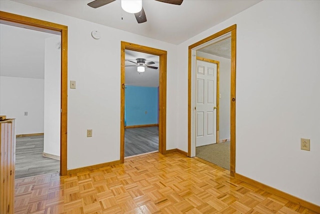 empty room featuring light parquet flooring and ceiling fan