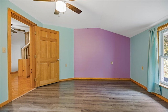 interior space with vaulted ceiling, hardwood / wood-style flooring, and ceiling fan