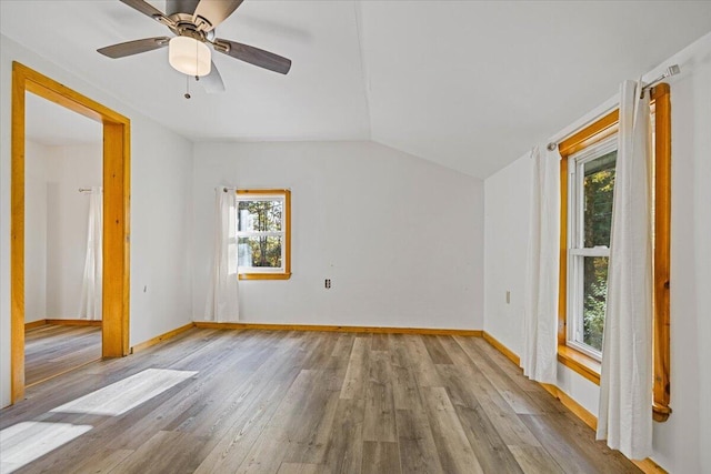 additional living space featuring ceiling fan, light wood-type flooring, plenty of natural light, and lofted ceiling