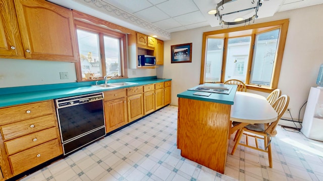 kitchen with a baseboard heating unit, a kitchen bar, a drop ceiling, dishwasher, and sink