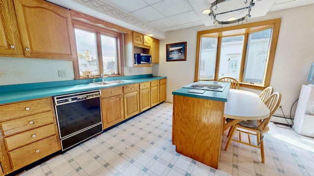 kitchen featuring light floors, a kitchen island, black dishwasher, stainless steel microwave, and a sink