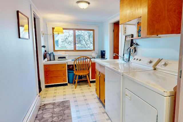 laundry room featuring cabinets, a baseboard radiator, sink, and independent washer and dryer