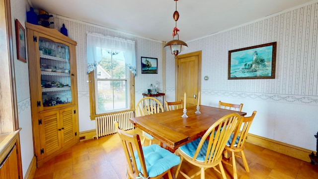 dining room featuring radiator and crown molding