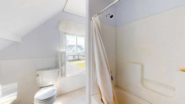 bathroom with shower / bath combination with curtain, toilet, and vaulted ceiling