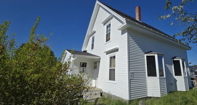 33 Carver St, Vinalhaven, ME 04863 - view of side of home featuring a chimney