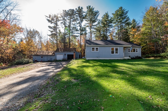 exterior space featuring a garage, a yard, and an outdoor structure