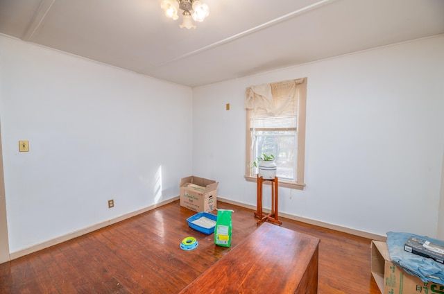 interior space with hardwood / wood-style flooring and crown molding