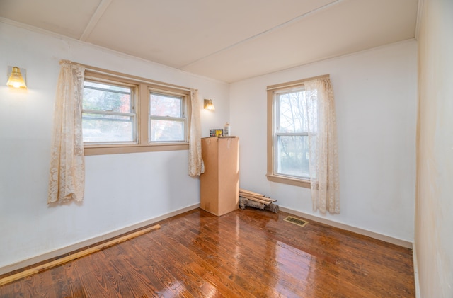 unfurnished room featuring hardwood / wood-style flooring