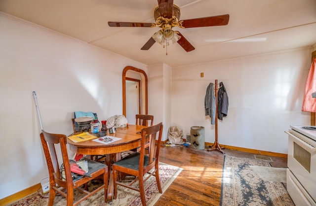 dining space with crown molding, hardwood / wood-style floors, and ceiling fan