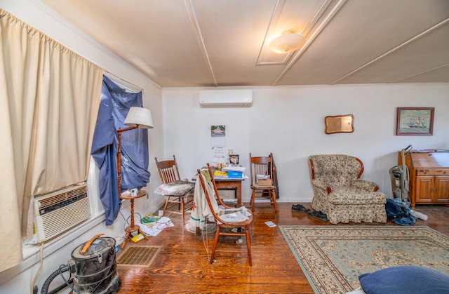 sitting room featuring cooling unit, a wall mounted AC, and dark hardwood / wood-style flooring