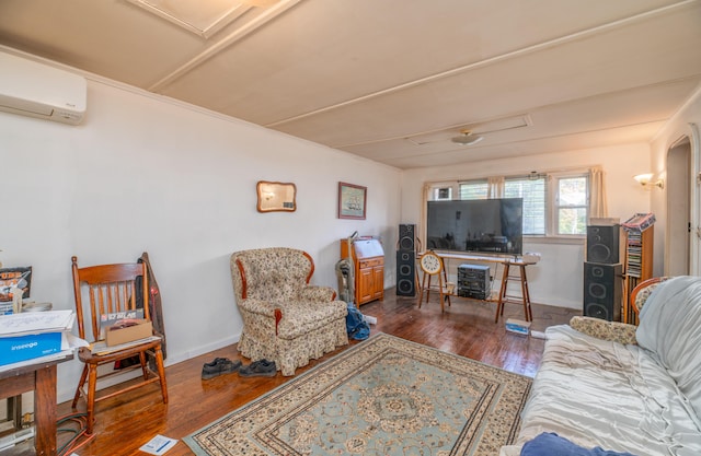 living room featuring dark wood-type flooring and a wall unit AC