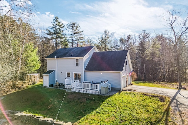 49 Balsam Dr, Waldoboro, ME 04572 - back of property with a yard, a deck, and a garage