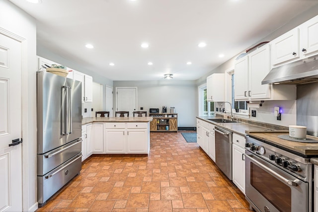49 Balsam Dr, Waldoboro, ME 04572 - kitchen featuring kitchen peninsula, white cabinetry, sink, and high end appliances