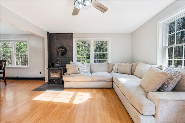 49 Balsam Dr, Waldoboro, ME 04572 - living room featuring hardwood / wood-style floors, ceiling fan, a wood stove, and a wealth of natural light