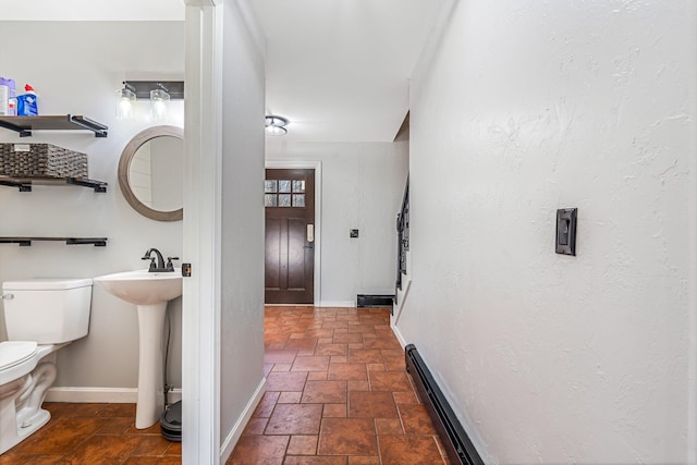 49 Balsam Dr, Waldoboro, ME 04572 - bathroom with a baseboard radiator, toilet, and sink