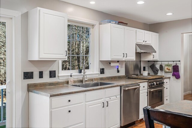 49 Balsam Dr, Waldoboro, ME 04572 - kitchen featuring white cabinets, decorative backsplash, stainless steel appliances, and sink