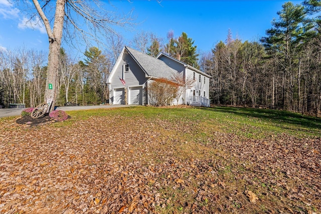 49 Balsam Dr, Waldoboro, ME 04572 - view of property exterior featuring a lawn and a garage