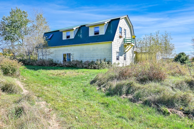 view of side of home featuring a lawn