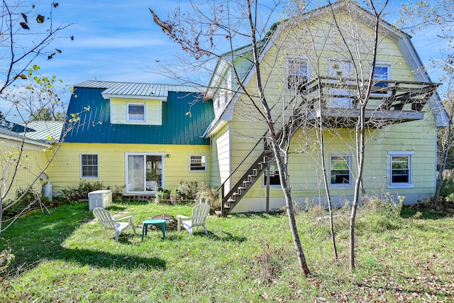 rear view of house with a yard