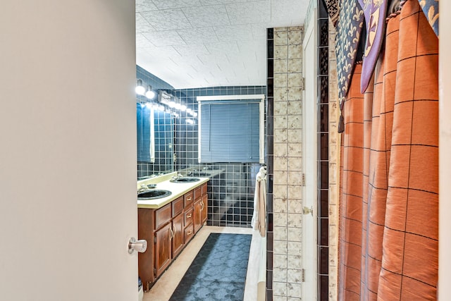 bathroom featuring vanity, tile patterned flooring, tile walls, and a shower with curtain