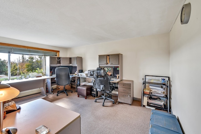 carpeted home office with a textured ceiling and baseboard heating