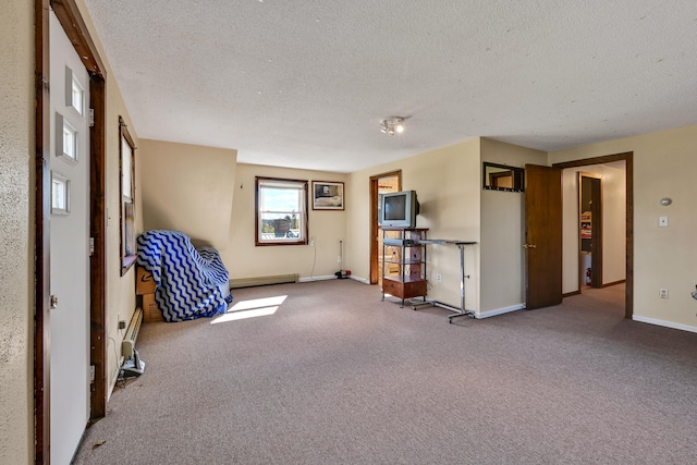 miscellaneous room with baseboard heating, carpet, and a textured ceiling