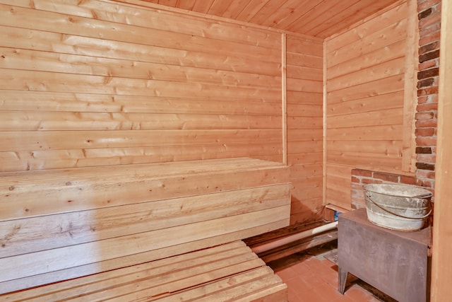 view of sauna / steam room with wood walls, wood ceiling, and tile patterned floors