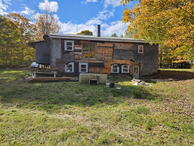 rear view of property with a yard