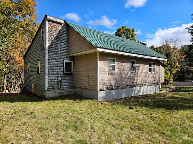 view of property exterior featuring a lawn