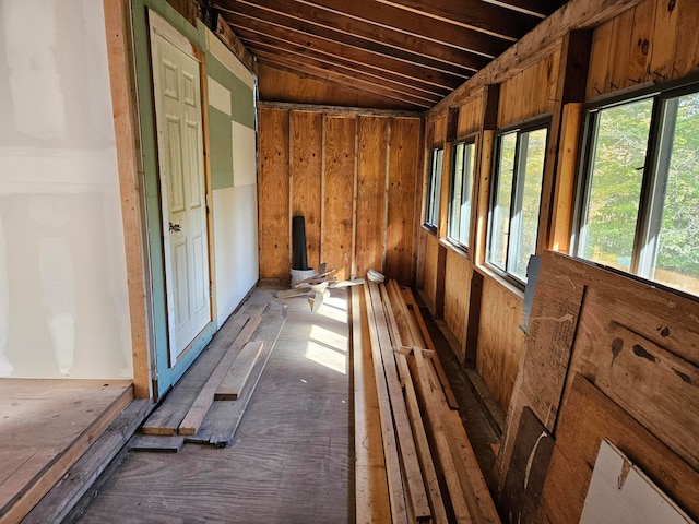 misc room with wood walls and vaulted ceiling