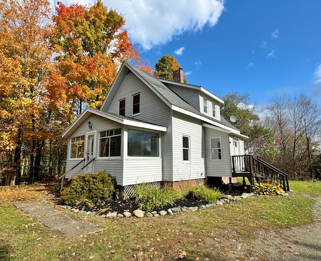 view of home's exterior featuring a lawn and a deck