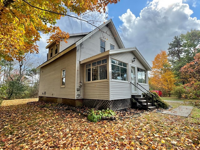 view of home's exterior featuring a sunroom