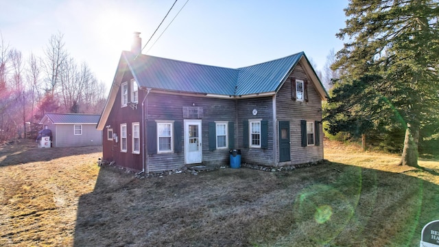 view of front of home with an outbuilding and a front yard