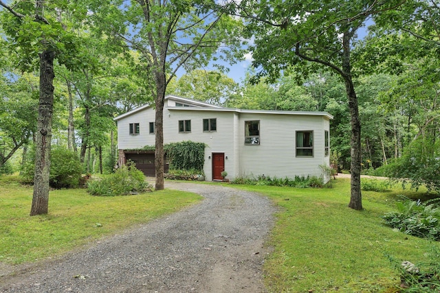view of front of house with a garage, a front yard, and driveway